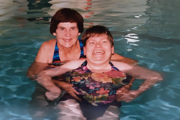 Photo is Bette in the pool in 1997 with Sharon, a person who is supported by Ongwanada.